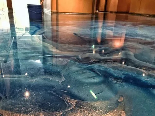 a blue epoxy floor with a shimmering water reflectiona